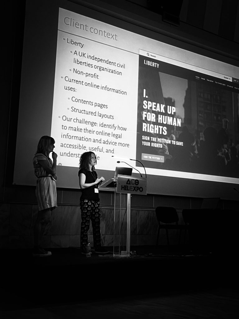 Rachel Warner and Emily Allbon presenting with presentation slide in the background