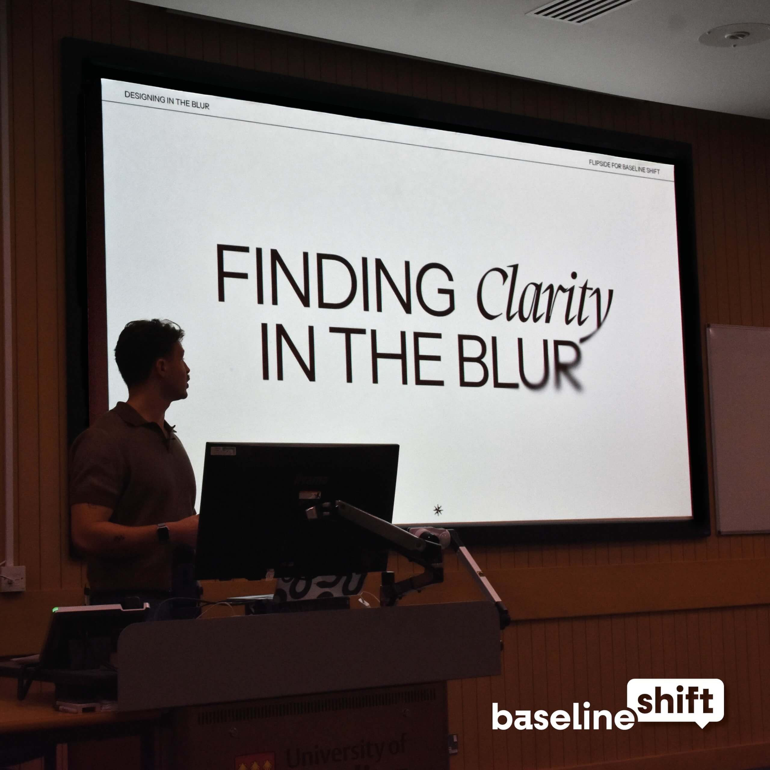 Albert parker standing in front of a screen giving a talk on Digital UX UI design as well as branding for Baseline Shift